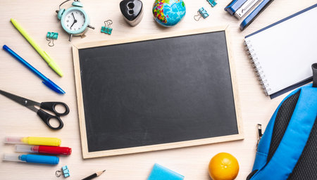 Stationery school supplies around the board. Top view and copy space. Concept of back to school.