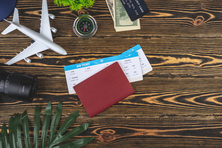 Layout of airplane travel accessories on a wooden background. Top view.の写真素材