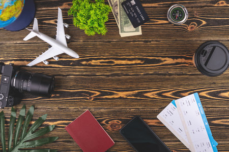 Layout of airplane travel accessories on a wooden background with copy space. Concept of trip and holiday.の写真素材