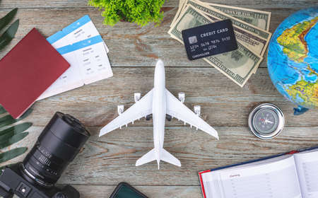 Documents, plane tickets and other travel supplies on a wooden background. Top view.の写真素材