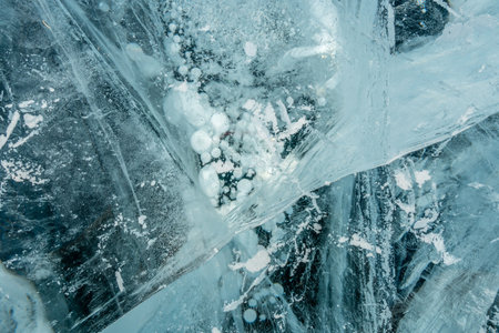 The texture of pure blue frozen cracked ice of lake Baikal. Drawings of natureの写真素材
