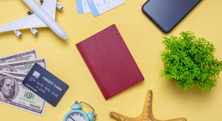 Layout of travel accessories on a yellow background. Concept of journey, vacations and air travel. Top view.の写真素材