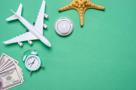 Miniature airplane and travel accessories on the green. Concept of vacations. Top view and copy space.の写真素材