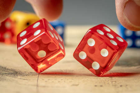 The hand is throwing the red dices on the map. The concept of board games and a lucky chance to winの写真素材