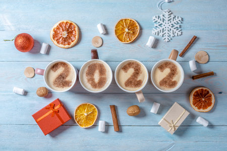 Card with numbers 2022 for New year and Christmas. Cup of coffee with figures on milk foam on blue wooden background. The view from the top. Flat layの写真素材
