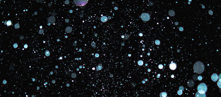 Blurred snowflakes on a dark background. Overlay image for snowfall effect.の写真素材