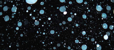 Blurred snowflakes on a dark background. Overlay image for snowfall effect.の写真素材