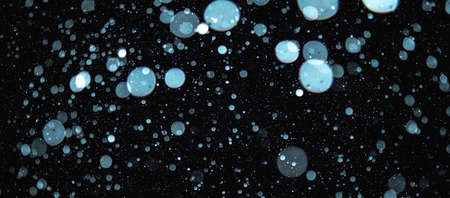 Blurred snowflakes on a dark background. Overlay image for snowfall effect.の写真素材
