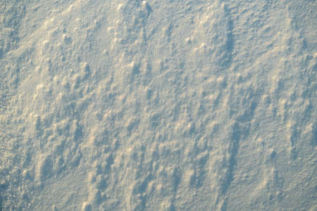 Uneven texture of snow in the sunset light.の写真素材