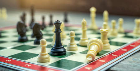 A chess board with pieces. The game ended with the defeat of the white king. The concept of strategy in businessの写真素材