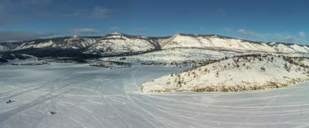 Beautiful landscape of winter snow-covered Lake Baikal and the surrounding mountains. bird's-eye view.の写真素材