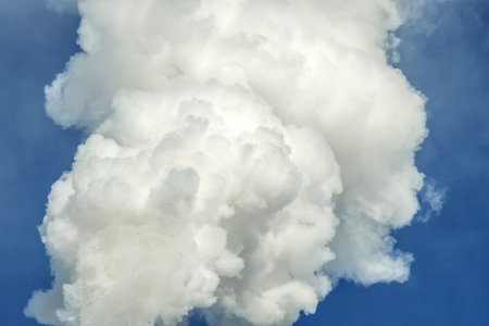Powerful industrial factory chimney is smoking and emitting carbon dioxide into the environment....