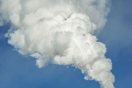 Powerful industrial factory chimney is smoking and emitting carbon dioxide into the environment. Concept of air pollution and the problem of global warmingの写真素材