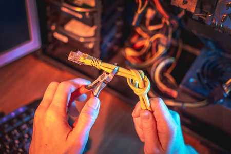 Cutting the Internet cable tied into a knot with wire cutters. The concept of disconnecting the Internet and restricting access to resourcesの写真素材