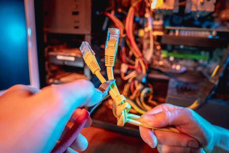Cutting the Internet cable tied into a knot with wire cutters. The concept of disconnecting the Internet and restricting access to resourcesの写真素材