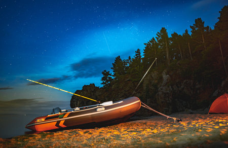 Fishing motor boat on the shore of Lake Baikal. Summer night landscape of unique nature.