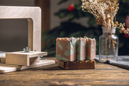 Cutting of homemade natural soap on a professional wood cutter. A means of eco-friendly hygiene and pleasant gifts.の写真素材