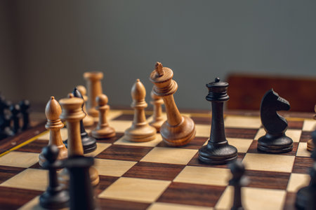 A wooden chessboard with pieces. Checkmate and the fall of the king by white.の写真素材