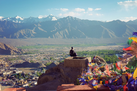 India - June 18, 2017: People sit on top of monastry with mantra flag beside to viewing mountain in Leh Ladakh, Indiaのeditorial素材