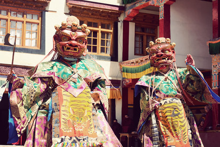 LAMAYURU, INDIA - JUNE 22, 2017: Unidentified buddhist lamas dressed in mystical mask dancing Tsam...
