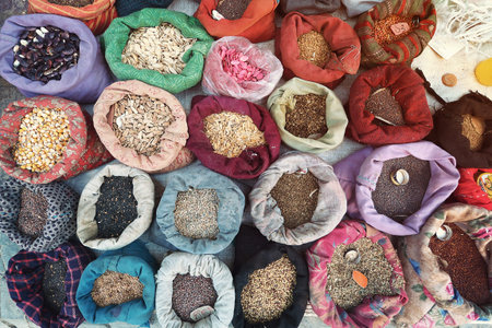Variety of indian herb in a bags sort on the ground - view from above