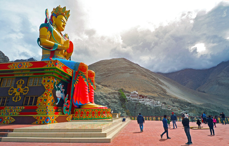 India - JUNE 20 2017: People praying Big Sitting Buddha Statue at Diskit Monastery with Himalaya mountains in the back - Nubra Valley, Ladakh, Indiaのeditorial素材