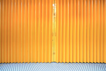 Yellow corrugated metal sheet slide door, conceptual background wallpaperの写真素材