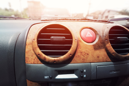  Image of a passenger air condition and emergency light button on wooden console in a luxury carの写真素材