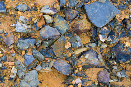 fresh and colorful, yellow, blue, black, purple ground sand and fragment stone surface background photoの写真素材