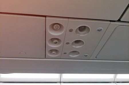 Plane cabin overhead panel control with air condition and light bulbの写真素材