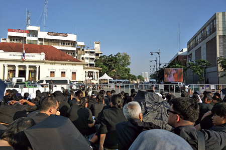 Bangkok Thailand - 26 October 2017: Group of many thai people sit on the street ground waiting for  King Bhumibol Adulyadej (King Rama 9) Royal cremation ceremony in very hot weather sunny at Sanamchai Roadのeditorial素材