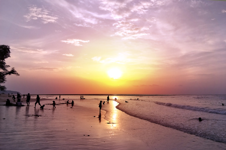 silhouette many of family and children playing enjoy on the beach with sunsetのeditorial素材
