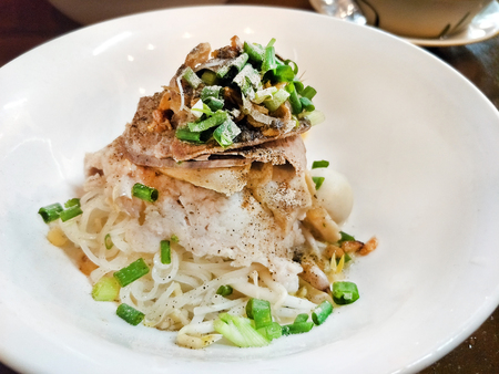 Thai local traditional street food dry noodles with pork called Kuay Teaw Sen Lek Hangの写真素材