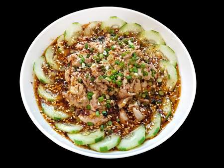 chinese dish - Kou Shui Ji; steamed Chicken in Sichuan pepper Chili Oil Sauce surround by cucumber served on white bowl - isolated on black backgroundの写真素材