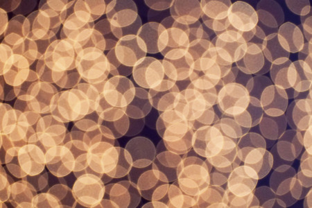 blurred many of bokeh photography in abstract background yellow color theme photo taken from led panelの写真素材