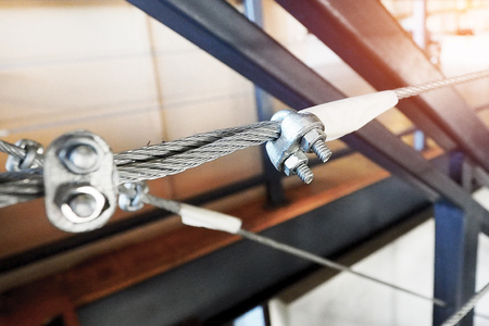 closeup photo of metalic sling with hook and knot bolt use to made a fenceの写真素材