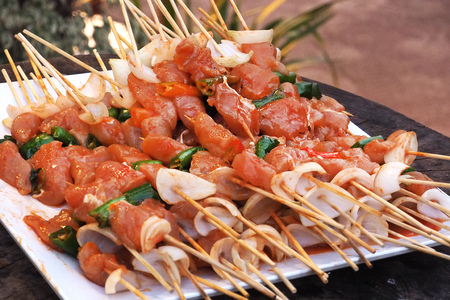 prepared many of raw BBQ  wooden stick on white ceramic square plate dishの写真素材