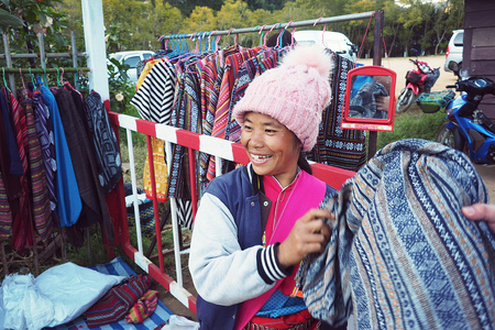 CHIANG MAI THAILAND - 30 January 2018: local woman from Mhong mountain tribe that locate close to Thailand and Myanmar border sell the hand made t-shirt at Doi Ang Khang, Chiang Mai, Thailandのeditorial素材