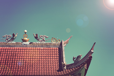 vintage photography effect - bird sculpture statue on roof top of pubclic chinese temple in Fang, Chiang Mai north of Thailandの写真素材