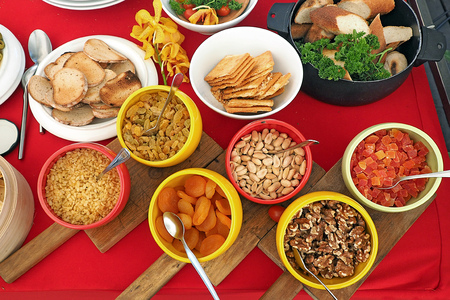 biscuit bread eat with variety choice of dried plum fruit and nuts at food buffet line on colorful red tableの写真素材