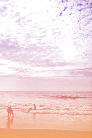 silhouette lifestyle happy family on the sea ocean beach with cloudy sky in sweet pastel color backgroundの写真素材