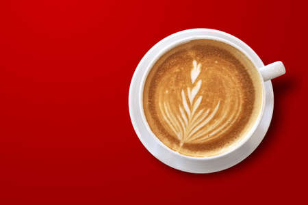 hot latte art coffee photo from above top view isolated on red backgroundの写真素材