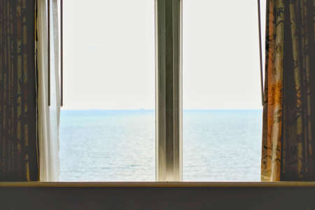 Window of the hotel with sea view in the morning time.の写真素材