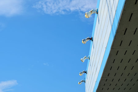 A view of blue sky with white and blue roof and light stick on the roof.