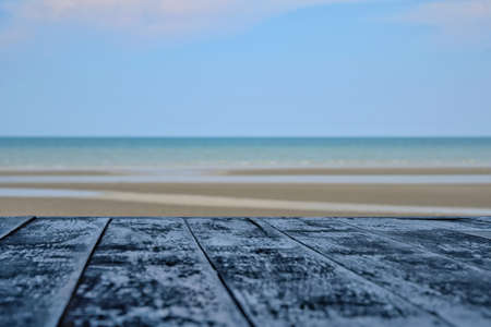 View of sand beach and sea and blue sky with the wooden table. Relax and vacation concept.の写真素材