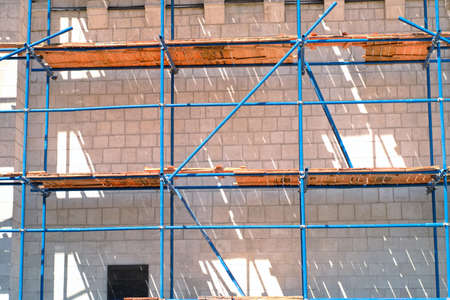 Maintenance team using a metal structure to protect in maintenance building phase.の写真素材