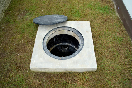 A hole of grease trap with the drain system around the house.