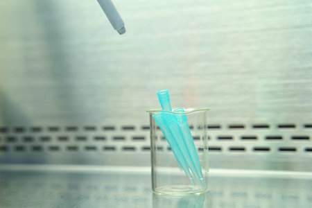 The researcher using pipette and splitting pipette tip from pipette in the lab test.