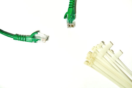 Green LAN cable with cable ties and cable strap on the white background.