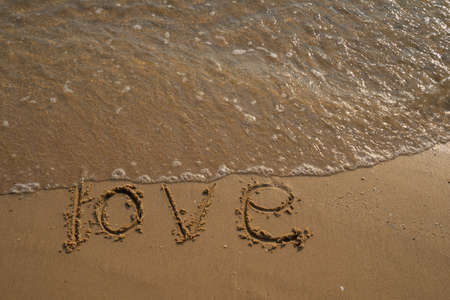 Love and Valentine concept. Love words written into the sand on the beach at Rayong, Thailandの写真素材
